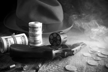 Guns and money.Gangster coat,bullet,dollars .The concept of crime.Smoky background.Retro and vintage style.