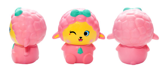 pink sheep toy with a blue bow on a white background