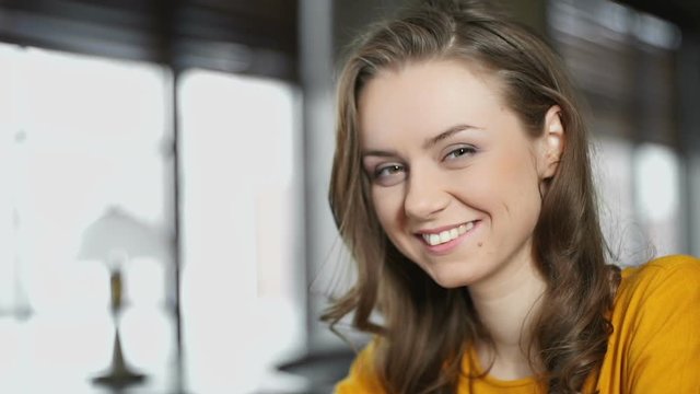 Smiling woman with cup of coffee looking at camera, restaurant service review
