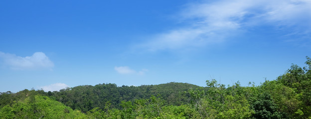 Fototapeta premium A summer alpine panorama of a wide thai valley with cloudy sky, haze and fresh green pastures 