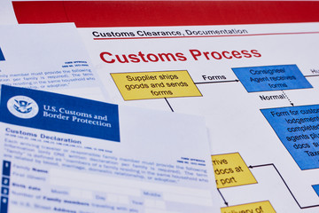 Page with the rules of customs process next to forms of the customs declaration