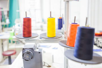 Colorful sewing threads spools at textile workshop