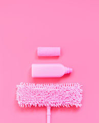 MOP, rag and detergent-pink set on pink background for spring cleaning. Copy space.