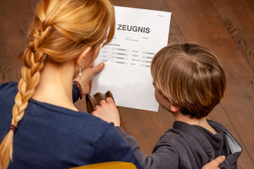 Mother comforting son despite the bad school certificate - Translation: certificate day of birth...