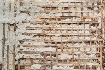 Old wooden wall covered with plaster