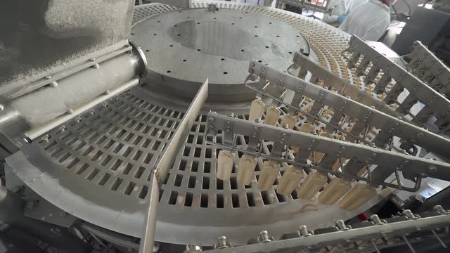 ice cream production, the automated process of extracting the ready ice cream from the forms, production line, dairy products.