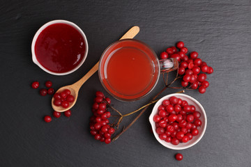 viburnum with juice, jam, tea on black background 