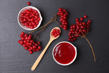 viburnum with juice, jam, tea on black background 