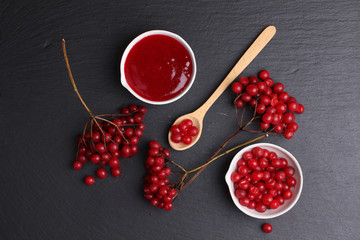 viburnum with juice, jam, tea on black background 