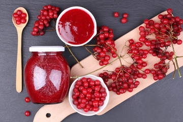 viburnum with juice, jam, tea on black background 