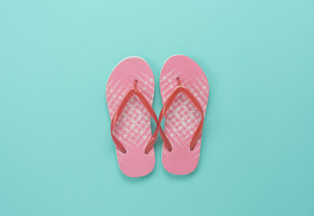 Table top view aerial image of sea fashion background concept.Flat lay sandals on modern beautiful rustic green paper at office desk.Free space for creative design text and wording.Pastel tone