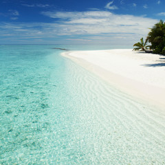 Tropical beach. White sand, blue sky and crystal sea of tropical beach. Ocean beach relax, travel to islands