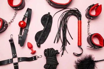 Set of erotic toys for BDSM. The game of sexual slavery with a whip, gag and leather blindfold. Intimate sex games. © adragan