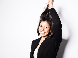 Business woman wearing a black suit posing in a studio