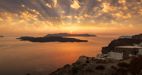 Fira, caldera, Santorini volcano, spectacular evening view at sunset on the beautiful island of Santorini, Dramatic sky with clouds. Greece