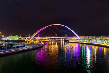 Light illuminated canal bridge and reflection of lights on river