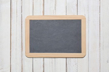 chalk blackboard on a white wooden deck background with copy space for your text