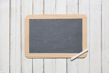 chalk blackboard on a white wooden deck background with copy space for your text