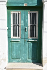 Green Mediterranean Double Doors with White Fixtures