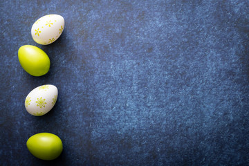 Easter background, green Easter eggs on a dark blue background.