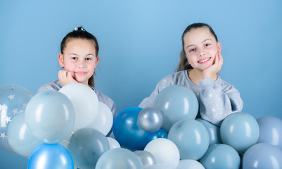 Fototapeta premium Happiness and cheerful moments. Carefree childhood. Sisters organize home party. Having fun concept. Balloon theme party. Girls best friends near air balloons. Start this party. Birthday party