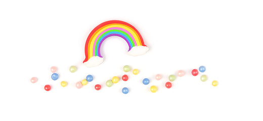 Obraz premium rainbow and colorful topping sprinkles. colorful rainbow and jelly beans on white background. creative idea of design holiday, festive, vacation, weather