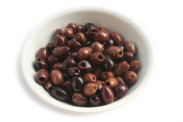 Italian Taggiasche olives in a bowl isolated on white background
