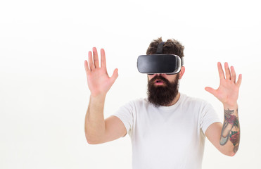 Portrait of an amazed guy using a virtual reality headset isolated on white background. A person in virtual glasses flies in room space. VR reality.