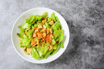 Stir Fry Snow Peas with Vietnamese Grilled Pork Sausage, topping with crispy fried shallots and garlics.