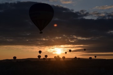 Sunrise and balloons. Beautiful background of the balloon and the sunset.Cappadocia. Turkey. Göreme. Nevşehir. Türkiye. 8. 04. 2019. Balloons flying over the rocky landscape in Cappadocia Turkey. View