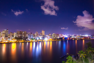 Naklejka na ściany i meble Beautiful Condado Beach, San Juan Puerto Rico seen at night with bay, buildings and lights