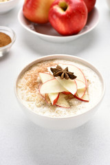 Oats porridge with red apple slices and cinnamon