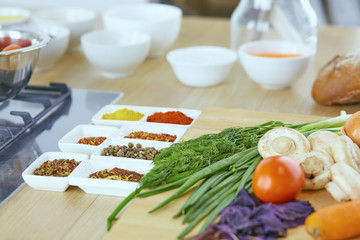 Composition with wooden board and ingredients for cooking on ta