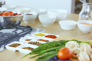 Composition with wooden board and ingredients for cooking on ta