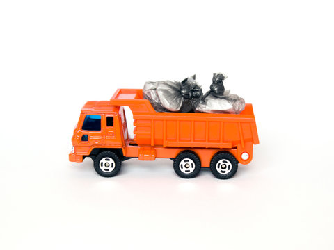 toy garbage truck with garbage bags isolated on white background