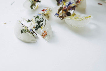 Ice cubes with frozen flowers. Cosmetology natural lifting 