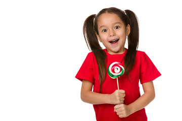 surprised cute little child girl with sweet candy lollipop isolated on white background