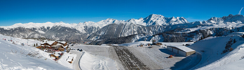 Altiport airport in a snow covered alpine mountain range