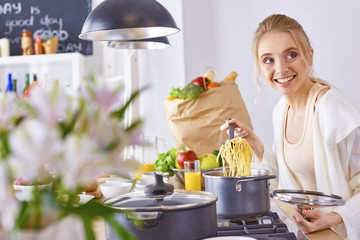 Young Woman Cooking in the kitchen. Healthy Food