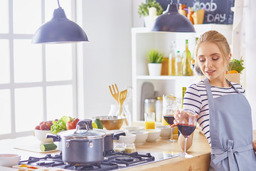 beautiful young woman using a digital tablet in the kitchen