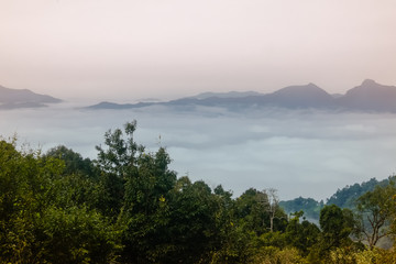Fototapeta na wymiar Sea of clouds at the dawn with a view of mountain range in the background, Nanthaburi National Park. Nan province, Thailand.