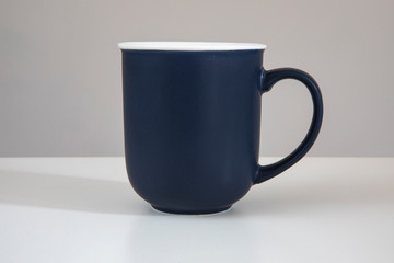Blue mug on a beige background.