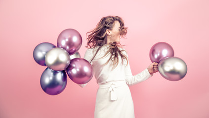 Fototapeta premium Young girl with balls on a colored background