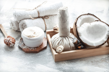 Fototapeta na wymiar Spa still life with fresh coconut and body care products