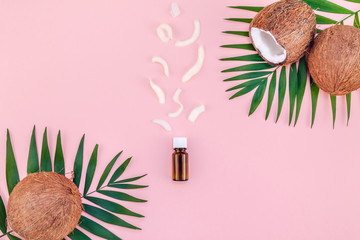 Palm leaves and coconuts on pink pastel background