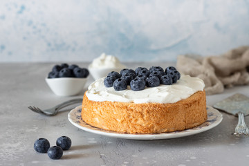 Angel food cake with whipped cream and fresh blueberries. 
