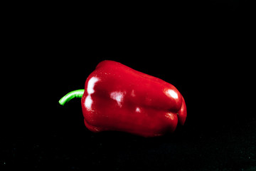 red sweet pepper, isolated nat dark background, lettuce pepper