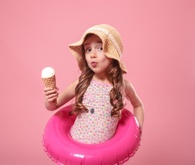 Portrait of a little cheerful girl with ice cream on a colored background