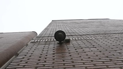 Outdoor Video Surveillance and Security Dome Camera Footage installed on a building wall - Outdoor CCTV surveillance system for buildings.