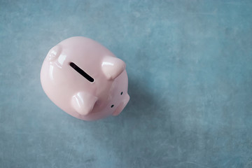 Pink piggy bank on a gray background.